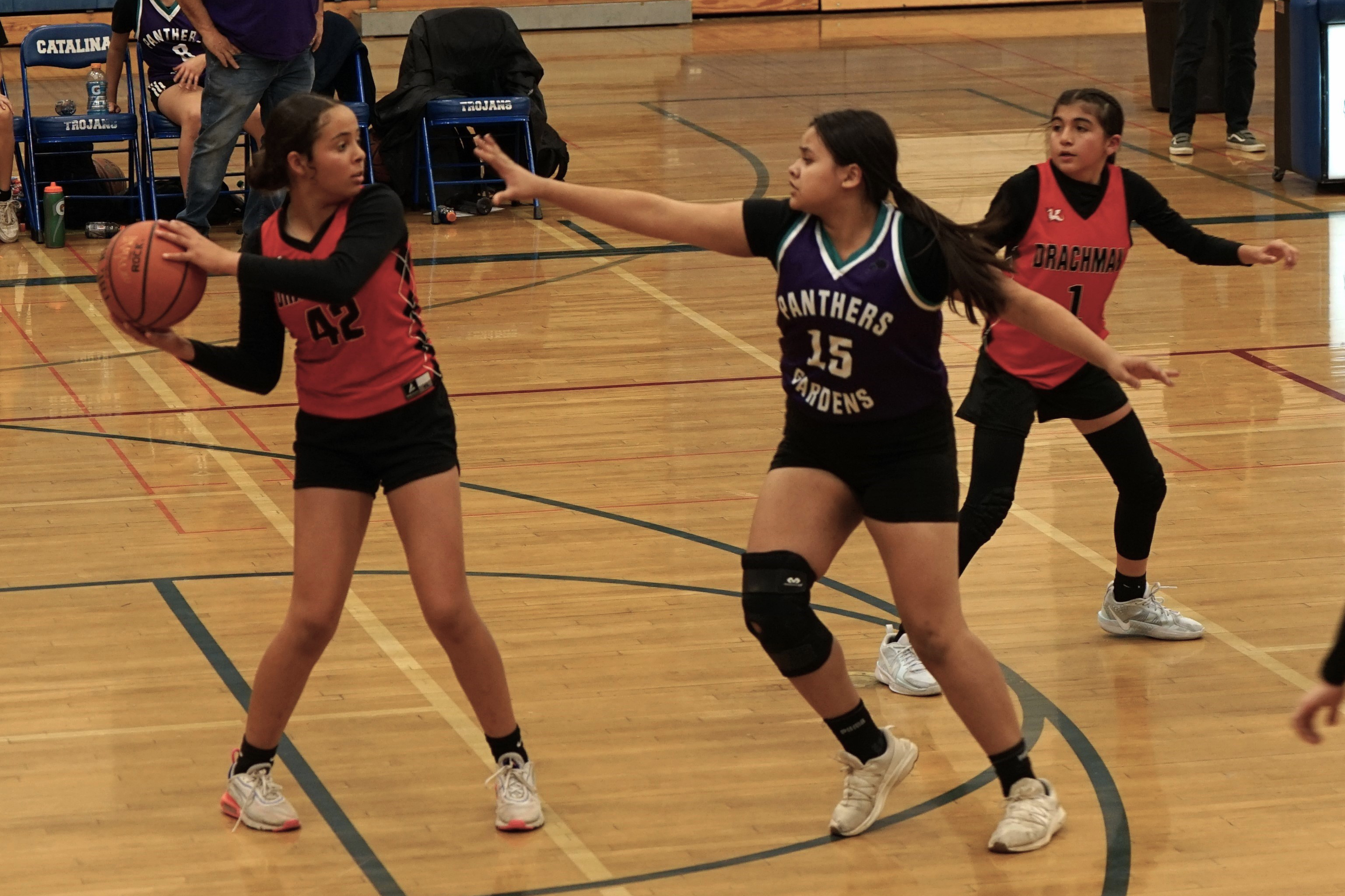 A Pueblo Gardens Panthers player tries to block a Drachman Dragons player from passing the ball