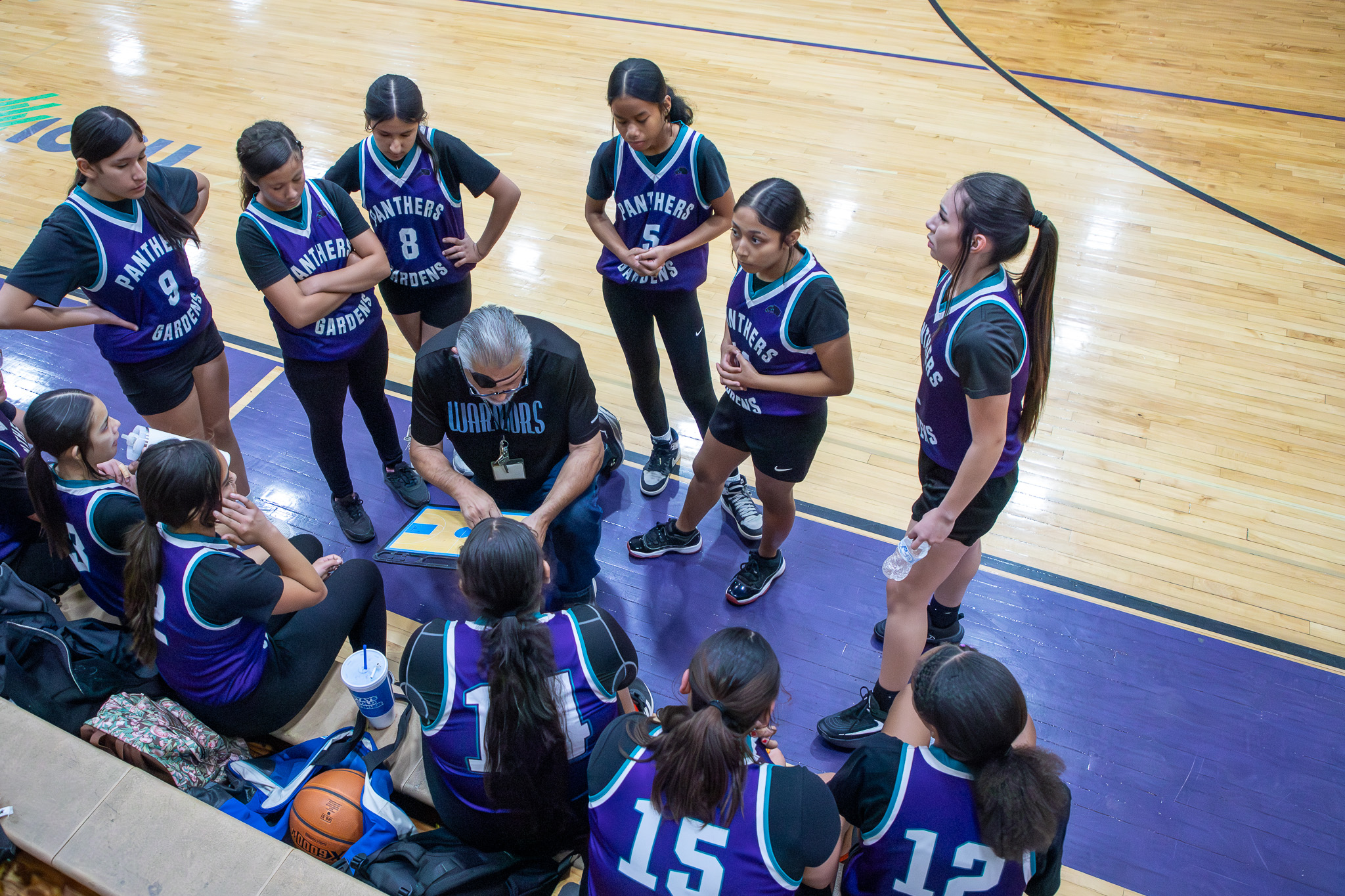 The Pueblo Gardens girls basketball team goes in for a huddle
