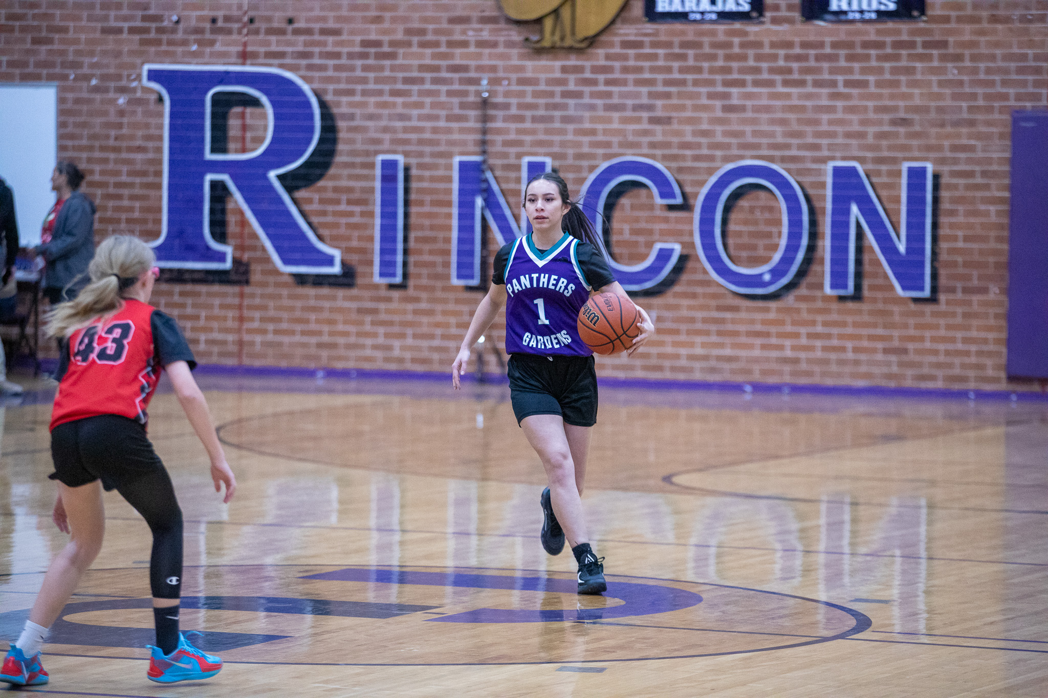 A Pueblo Gardens girl tries to keep the basketball away from her opponent