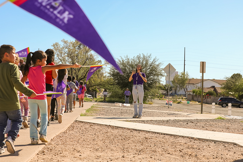 Students walk around the campus with their purple Ruby Bridges pennants